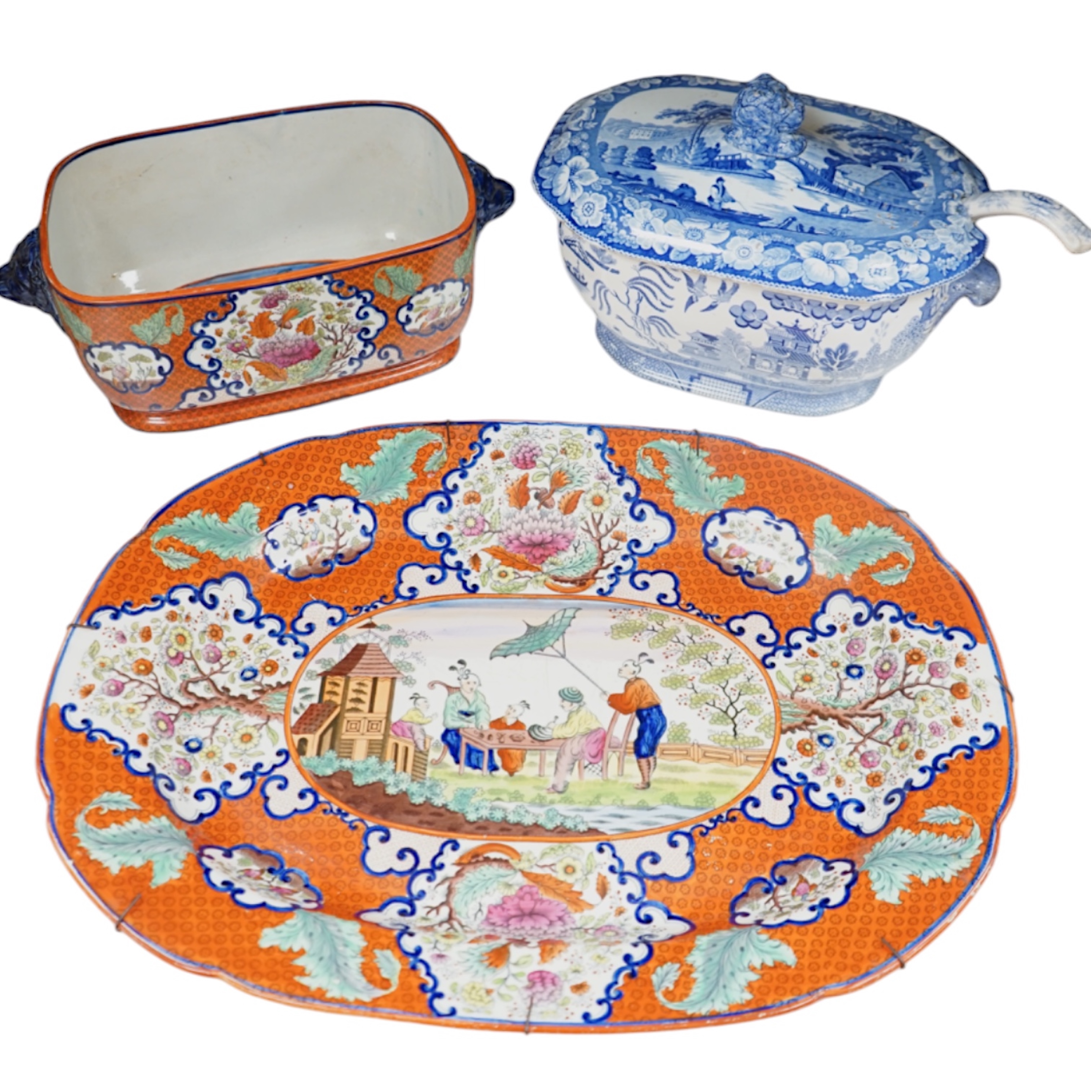 A large early to mid 19th century Pearlware meat platter and tureen without cover decorated with the ‘doctor calling’ pattern with a blue and white tureen cover and ladle, meat platter 54cm wide (3). Condition - fair